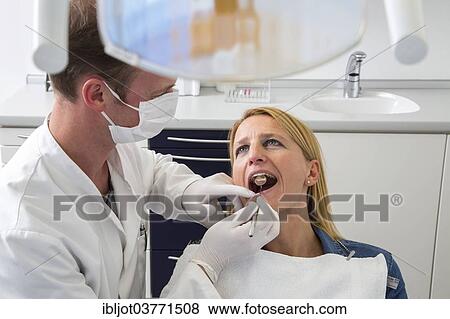 "Woman at the dentist, dentist checking her teeth, Germany, Europe" View Large Photo Image Stock Photo - "Woman at the dentist, dentist checking her teeth, Germany, Europe". Fotosearch
