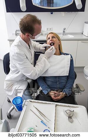 "Woman at the dentist, dentist checking her teeth, Germany, Europe" View Large Photo Image Stock Photography - "Woman at the dentist, dentist checking her teeth, Germany, Europe". Fotosearch