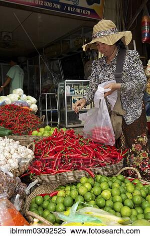 "Woman buying chili peppers at a market stall, Siem Reap, Siem Reap, Siem Reap Province, Cambodia, Asia" View Large Photo Image Stock Photography - "Woman buying chili peppers at a market stall, Siem Reap, Siem Reap, Siem Reap Province, Cambodia, Asia". Fotosearch