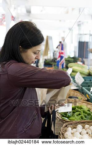 "Woman buying vegetables in a local market, Tiverton, Devon, England, United Kingdom, Europe" View Large Photo Image Picture - "Woman buying vegetables in a local market, Tiverton, Devon, England, United Kingdom, Europe". Fotosearch
