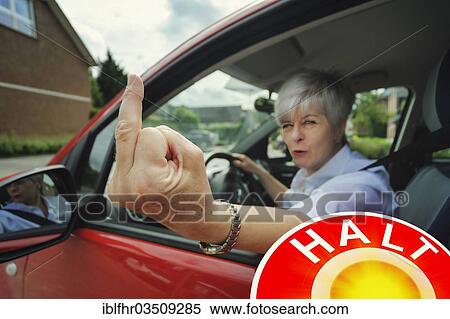 "Woman car driver making a rude hand gesture during a traffic control, Grevenbroich, Rhineland, North Rhine-Westphalia, Germany, Europe" View Large Photo Image Stock Photography - "Woman car driver making a rude hand gesture during a traffic control, Grevenbroich, Rhineland, North Rhine-Westphalia, Germany, Europe". Fotosearch