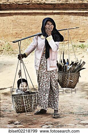 "Woman carrying a child in a basket, Bagan, Burma also known as Myanmar, Southeast Asia, Asia" View Large Photo Image Stock Photo - "Woman carrying a child in a basket, Bagan, Burma also known as Myanmar, Southeast Asia, Asia". Fotosearch