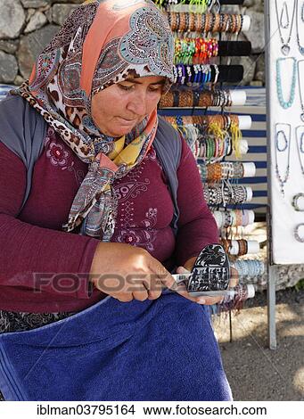 Picture - "Woman carving a stone, ancient city of Tlos in the Xanthos Valley, Mugla Province, Lycia, Aegean, Turkey, Asia". Fotosearch