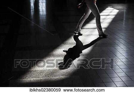 Stock Photo - "Woman casting a shadow on the floor of a building, Leipzig, Saxony, Germany, Europe". Fotosearch