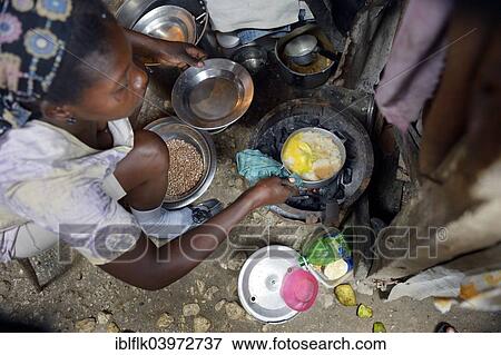 "Woman cooking in the improvised kitchen of a ramshackle hut, Camp Icare, camp for earthquake refugees, Fort National, Port-au-Prince, Haiti, North America" View Large Photo Image Stock Photo - "Woman cooking in the improvised kitchen of a ramshackle hut, Camp Icare, camp for earthquake refugees, Fort National, Port-au-Prince, Haiti, North America". Fotosearch