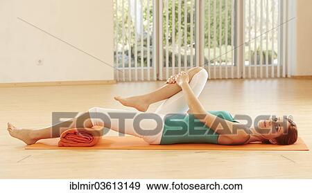 Stock Photo - Woman doing pelvic floor exercises. Fotosearch