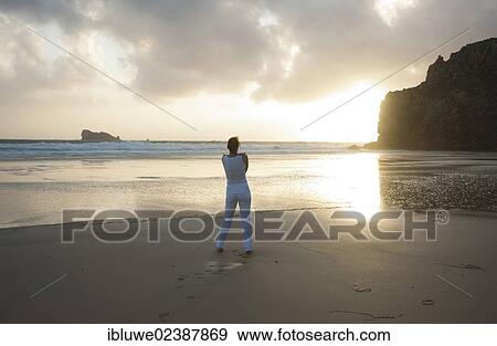 Woman doing relaxation exercises on a beach at sunset View Large Photo Image Stock Photo - Woman doing relaxation exercises on a beach at sunset. Fotosearch