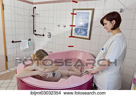 "Woman during childbirth with a cardiotocography or CTG in a birthing bath in the maternity delivery room with her midwife, Germany, Europe" View Large Photo Image Picture - "Woman during childbirth with a cardiotocography or CTG in a birthing bath in the maternity delivery room with her midwife, Germany, Europe". Fotosearch