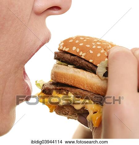 "Woman eating a burger, close up" View Large Photo Image Picture - "Woman eating a burger, close up". Fotosearch