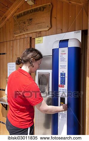 "Woman extracting fresh milk from a milk vending machine in Novo Mesto, Slovenia, Europe" View Large Photo Image Stock Photography - "Woman extracting fresh milk from a milk vending machine in Novo Mesto, Slovenia, Europe". Fotosearch