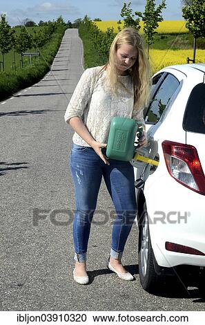 "Woman filling petrol into her car from a petrol can, Skane, Sweden, Europe" View Large Photo Image Stock Image - "Woman filling petrol into her car from a petrol can, Skane, Sweden, Europe". Fotosearch