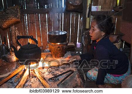 "Woman from the Lahu people, hill tribe, ethnic minority, cooking on an open fire in a kitchen made of bamboo, Mae Hong Son Province, Northern Thailand, Thailand, Asia" View Large Photo Image Stock Photo - "Woman from the Lahu people, hill tribe, ethnic minority, cooking on an open fire in a kitchen made of bamboo, Mae Hong Son Province, Northern Thailand, Thailand, Asia". Fotosearch