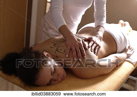 Woman having her back massaged View Large Photo Image Stock Photo - Woman having her back massaged. Fotosearch