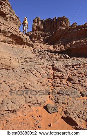 "Woman hiking in Tin Merzouga, Tadrart region, Unesco World Heritage Site Tassili n' Ajjer National Park, Sahara, Algeria, Africa" View Large Photo Image Stock Image - "Woman hiking in Tin Merzouga, Tadrart region, Unesco World Heritage Site Tassili n' Ajjer National Park, Sahara, Algeria, Africa". Fotosearch