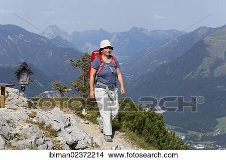 "Woman hiking on a path to the summit of Katrin mountain, Katergebirge mountains near Bad Ischl, Salzkammergut resort area, Traunviertel region, Upper Austria, Austria, Europe" View Large Photo Image Picture - "Woman hiking on a path to the summit of Katrin mountain, Katergebirge mountains near Bad Ischl, Salzkammergut resort area, Traunviertel region, Upper Austria, Austria, Europe". Fotosearch