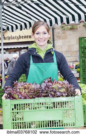"Woman holding a crate of salad, farmers' market in the market square, Esslingen am Neckar, Baden-Wuerttemberg, Germany, Europe" View Large Photo Image Stock Image - "Woman holding a crate of salad, farmers' market in the market square, Esslingen am Neckar, Baden-Wuerttemberg, Germany, Europe". Fotosearch