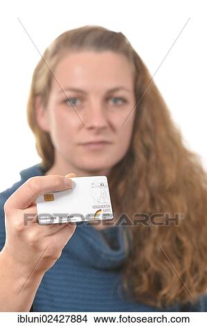 Picture - Woman holding a health insurance card. Fotosearch