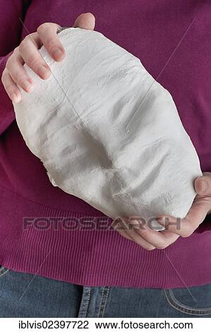 Woman holding a mask with a smiling face View Large Photo Image Stock Image - Woman holding a mask with a smiling face. Fotosearch