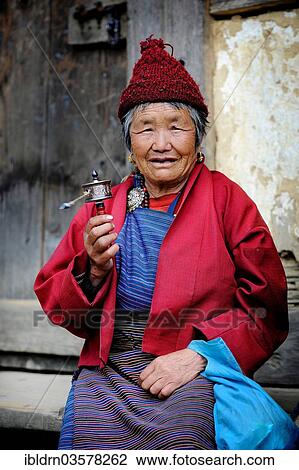 "Woman holding a prayer wheel, Pela La Pass, Wangdue Phodrang District, Bhutan, Asia" View Large Photo Image Stock Image - "Woman holding a prayer wheel, Pela La Pass, Wangdue Phodrang District, Bhutan, Asia". Fotosearch