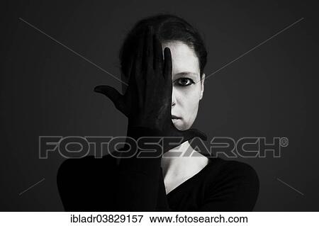 Woman holding her hands with black gloves in front of her face View Large Photo Image Stock Photo - Woman holding her hands with black gloves in front of her face. Fotosearch