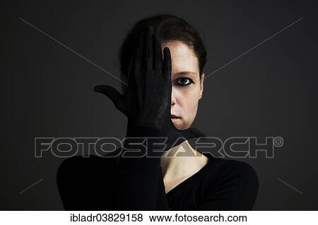 Woman holding her hands with black gloves in front of her face View Large Photo Image Stock Photo - Woman holding her hands with black gloves in front of her face. Fotosearch
