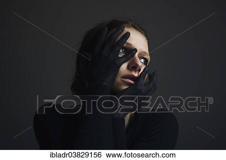 Woman holding her hands with black gloves in front of her face View Large Photo Image Stock Photograph - Woman holding her hands with black gloves in front of her face. Fotosearch