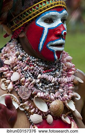 "Woman in a colourfully decorated costume with face paint is celebrating at the traditional Sing Sing gathering in the highlands, Paya, Papua New Guinea, Oceania" View Large Photo Image Stock Photograph - "Woman in a colourfully decorated costume with face paint is celebrating at the traditional Sing Sing gathering in the highlands, Paya, Papua New Guinea, Oceania". Fotosearch