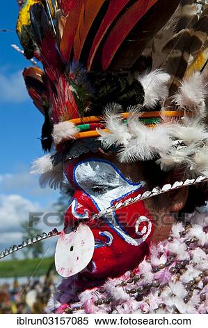 Stock Photography - "Woman in a colourfully decorated costume with face paint at the traditional sing-sing gathering, Hochland, Mount Hagen, Western Highlands Province, Papua New Guinea, Oceania". Fotosearch