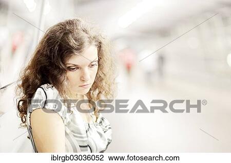 Stock Image - "Woman in a public space, looking down, Allgaeu, Kempten, Allgau, Swabia, Bavaria, Germany, Europe". Fotosearch