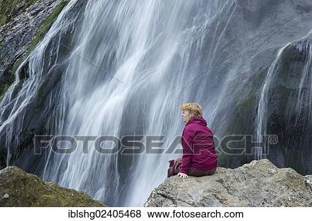 Stock Photo - "Woman in front of Powerscourt Waterfall, County Wicklow, Ireland, Europe". Fotosearch