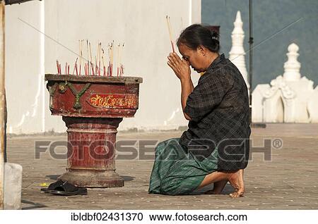 "Woman in prayer holding incense sticks, Temple complex of Wat Phra That Doi Kong Mu, Mae Hong Son, Northern Thailand, Thailand, Asia" View Large Photo Image Stock Image - "Woman in prayer holding incense sticks, Temple complex of Wat Phra That Doi Kong Mu, Mae Hong Son, Northern Thailand, Thailand, Asia". Fotosearch