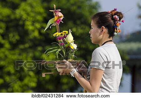 Picture - "Woman in prayer, holding offerings, Temple complex of Wat Jong Kham and Chong Kham and Wat Jong Klang and Chong Klang, Mae Hong Son, Northern Thailand, Thailand, Asia". Fotosearch