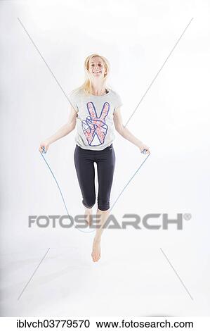 Woman in sportswear jumping rope View Large Photo Image Stock Image - Woman in sportswear jumping rope. Fotosearch