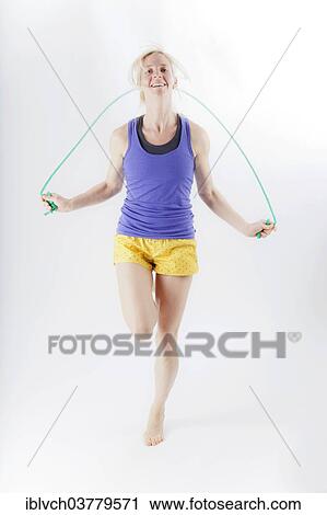 Woman in sportswear jumping rope View Large Photo Image Stock Image - Woman in sportswear jumping rope. Fotosearch