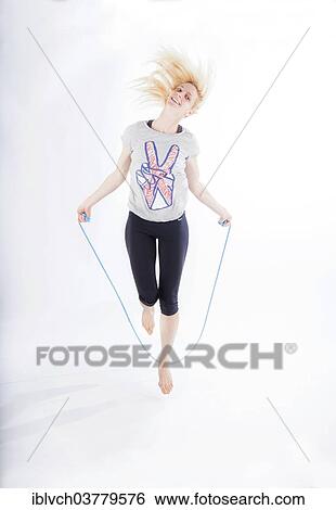Woman in sportswear jumping rope View Large Photo Image Stock Photograph - Woman in sportswear jumping rope. Fotosearch