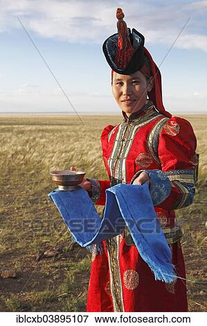 "Woman in traditional dress with traditional welcome utensils, blue cloth and bowl of milk, Gobi desert, Sudwuste, Omnogovi Province, Mongolia, Asia" View Large Photo Image Stock Photo - "Woman in traditional dress with traditional welcome utensils, blue cloth and bowl of milk, Gobi desert, Sudwuste, Omnogovi Province, Mongolia, Asia". Fotosearch