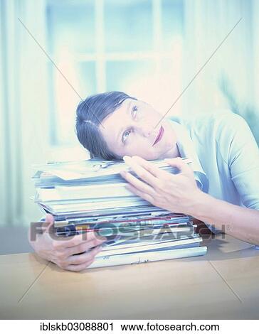 Woman laying her head on a stack of magazines and looking up View Large Photo Image Stock Image - Woman laying her head on a stack of magazines and looking up. Fotosearch