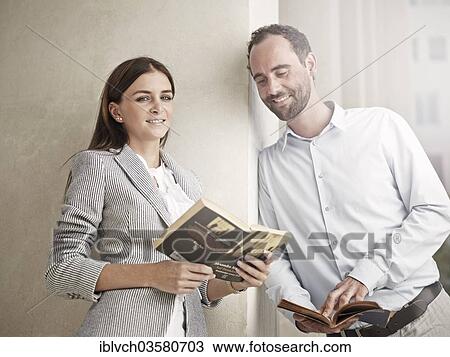 "Woman leaning against a wall and reading a book, man looking curiously into her book, Innsbruck, Tyrol, Austria, Europe" View Large Photo Image Stock Image - "Woman leaning against a wall and reading a book, man looking curiously into her book, Innsbruck, Tyrol, Austria, Europe". Fotosearch