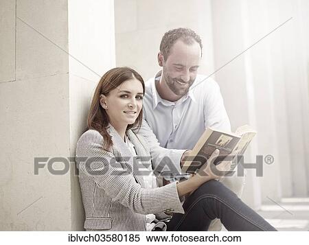 "Woman leaning against a wall and reading a book, man looking curiously into her book, Innsbruck, Tyrol, Austria, Europe" View Large Photo Image Stock Photography - "Woman leaning against a wall and reading a book, man looking curiously into her book, Innsbruck, Tyrol, Austria, Europe". Fotosearch