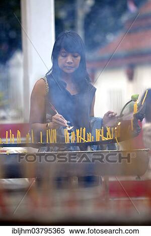 "Woman lighting candles outside the Wat Phra Si Rattana Mahathat Temple, Phitsanulok, Northern Thailand, Thailand, Asia" View Large Photo Image Stock Photography - "Woman lighting candles outside the Wat Phra Si Rattana Mahathat Temple, Phitsanulok, Northern Thailand, Thailand, Asia". Fotosearch