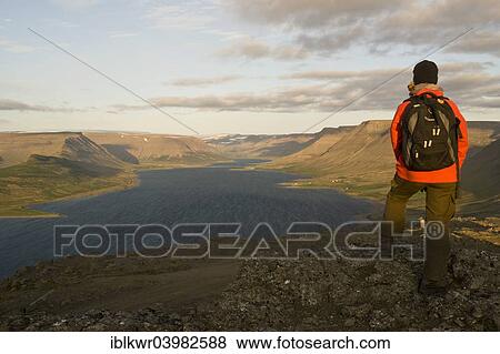 "Woman looking across Dyrafjordur Fjord, Westfjords, Iceland, Europe" View Large Photo Image Stock Photo - "Woman looking across Dyrafjordur Fjord, Westfjords, Iceland, Europe". Fotosearch