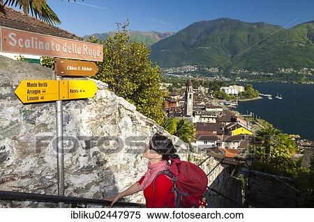 "Woman looking at a signpost while hiking, Ascona, Lake Maggiore, Ticino, Switzerland, Europe" View Large Photo Image Stock Photography - "Woman looking at a signpost while hiking, Ascona, Lake Maggiore, Ticino, Switzerland, Europe". Fotosearch