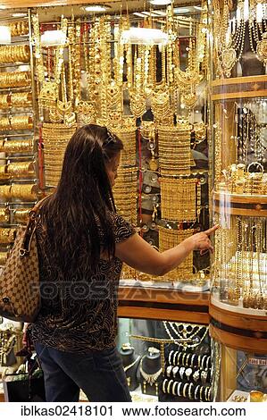 Woman looking at gold jewellery in a shop window, Gold Souk, Deira, Dubai, United Arab Emirates, Middle East, Asia View Large Photo Image Stock Image - Woman looking at gold jewellery in a shop window, Gold Souk, Deira, Dubai, United Arab Emirates, Middle East, Asia. Fotosearch