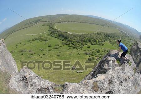 "Woman looking down a cliff, Crimean Mountains, Crimea, Ukraine, Europe" View Large Photo Image Stock Photograph - "Woman looking down a cliff, Crimean Mountains, Crimea, Ukraine, Europe". Fotosearch