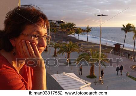 "Woman looking from balcony over promenade of Puerto Naos, La Palma, Canary Islands, Spain, Europe" View Large Photo Image Stock Image - "Woman looking from balcony over promenade of Puerto Naos, La Palma, Canary Islands, Spain, Europe". Fotosearch