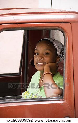 "Woman looking out of a car window, Havana, Cuba, North America" View Large Photo Image Stock Image - "Woman looking out of a car window, Havana, Cuba, North America". Fotosearch