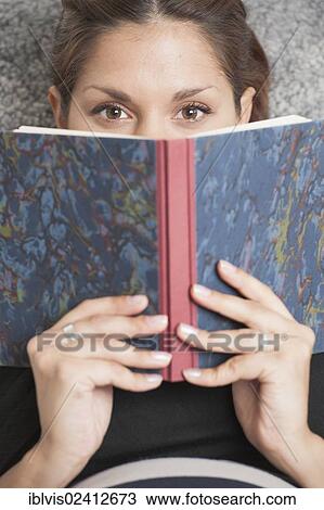 Woman lying in lounge chair and reading a diary View Large Photo Image Stock Image - Woman lying in lounge chair and reading a diary. Fotosearch