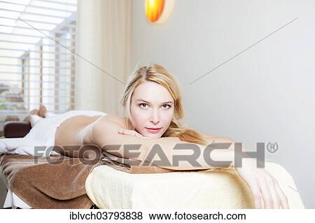 Woman lying on a massage table View Large Photo Image Stock Photo - Woman lying on a massage table. Fotosearch