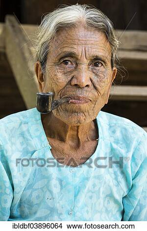 "Woman of the Chin people, ethnic minority, with a traditional facial tattoo smoking a pipe, the last of their kind, portrait, Rakhine State, Myanmar, Asia" View Large Photo Image Picture - "Woman of the Chin people, ethnic minority, with a traditional facial tattoo smoking a pipe, the last of their kind, portrait, Rakhine State, Myanmar, Asia". Fotosearch