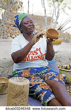 "Woman of the Kapsiki ethnic group drawing patterns on a bowl made of clay, cow dung and goat dung, Rhumsiki, Far North, Cameroon, Africa" View Large Photo Image Stock Photo - "Woman of the Kapsiki ethnic group drawing patterns on a bowl made of clay, cow dung and goat dung, Rhumsiki, Far North, Cameroon, Africa". Fotosearch